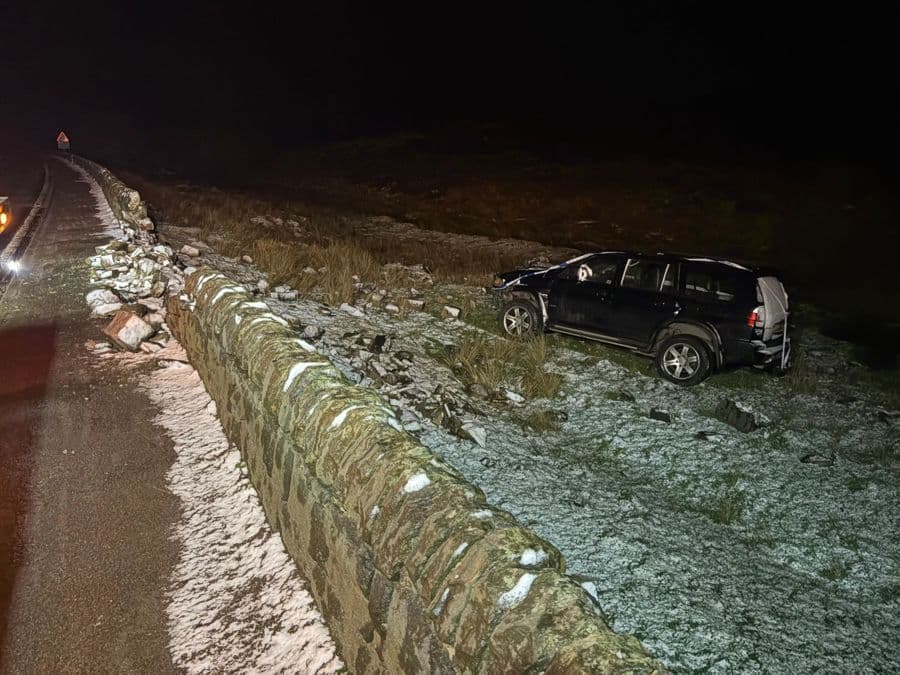 An SUV recovered off-road at night in the snow